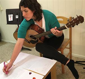 Meghan Feeman works on a video for her music therapy students 